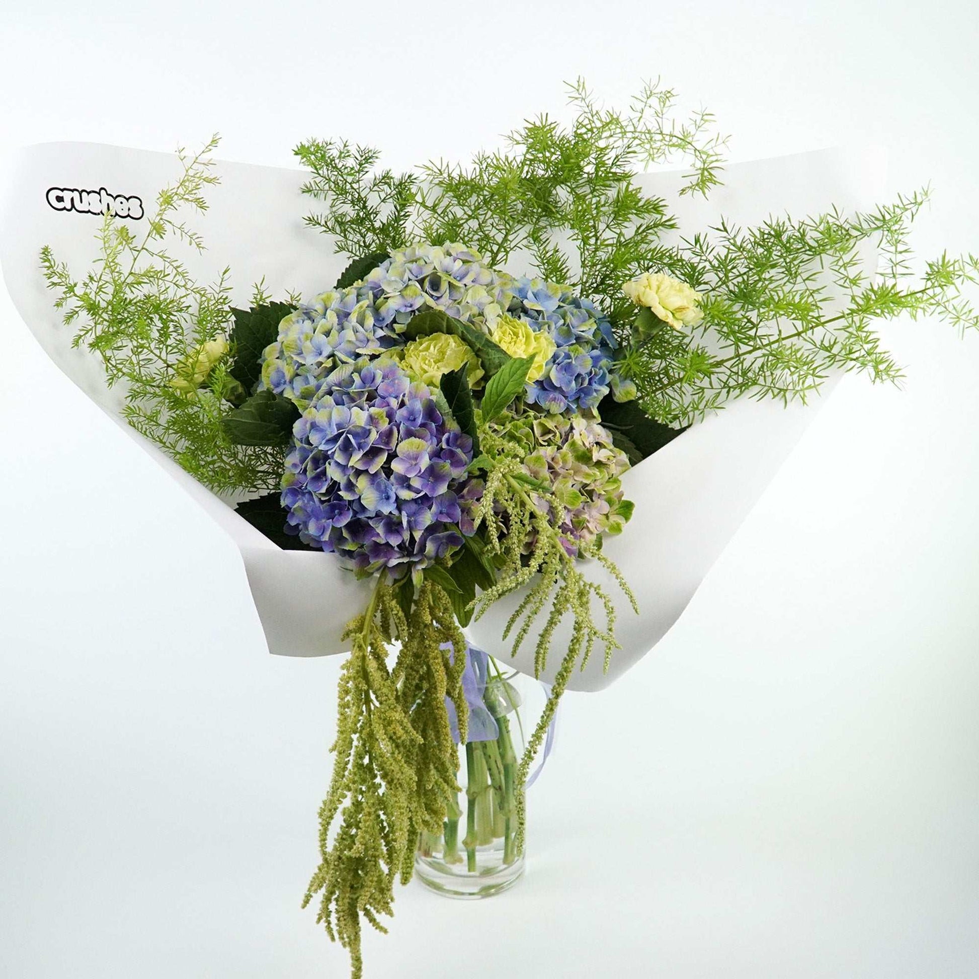 Sculptural green floral arrangement with anthuriums, hydrangea, and molucca balm. Monochrome Bouquet.