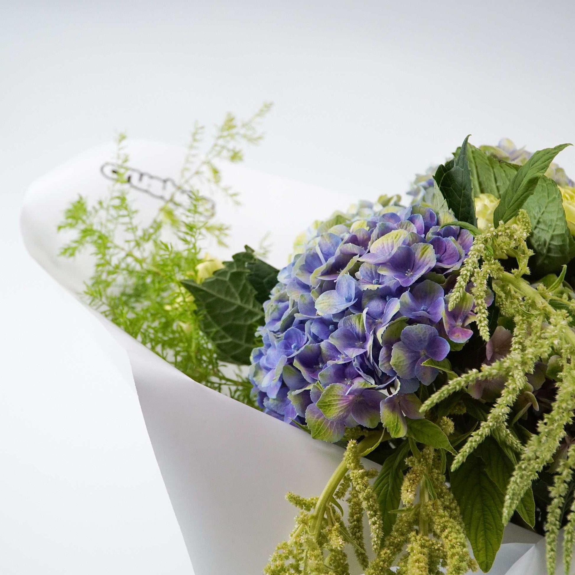 The No.02 Monochrome Bouquet floral arrangement with green antheriums, hydrangea, and foliage.