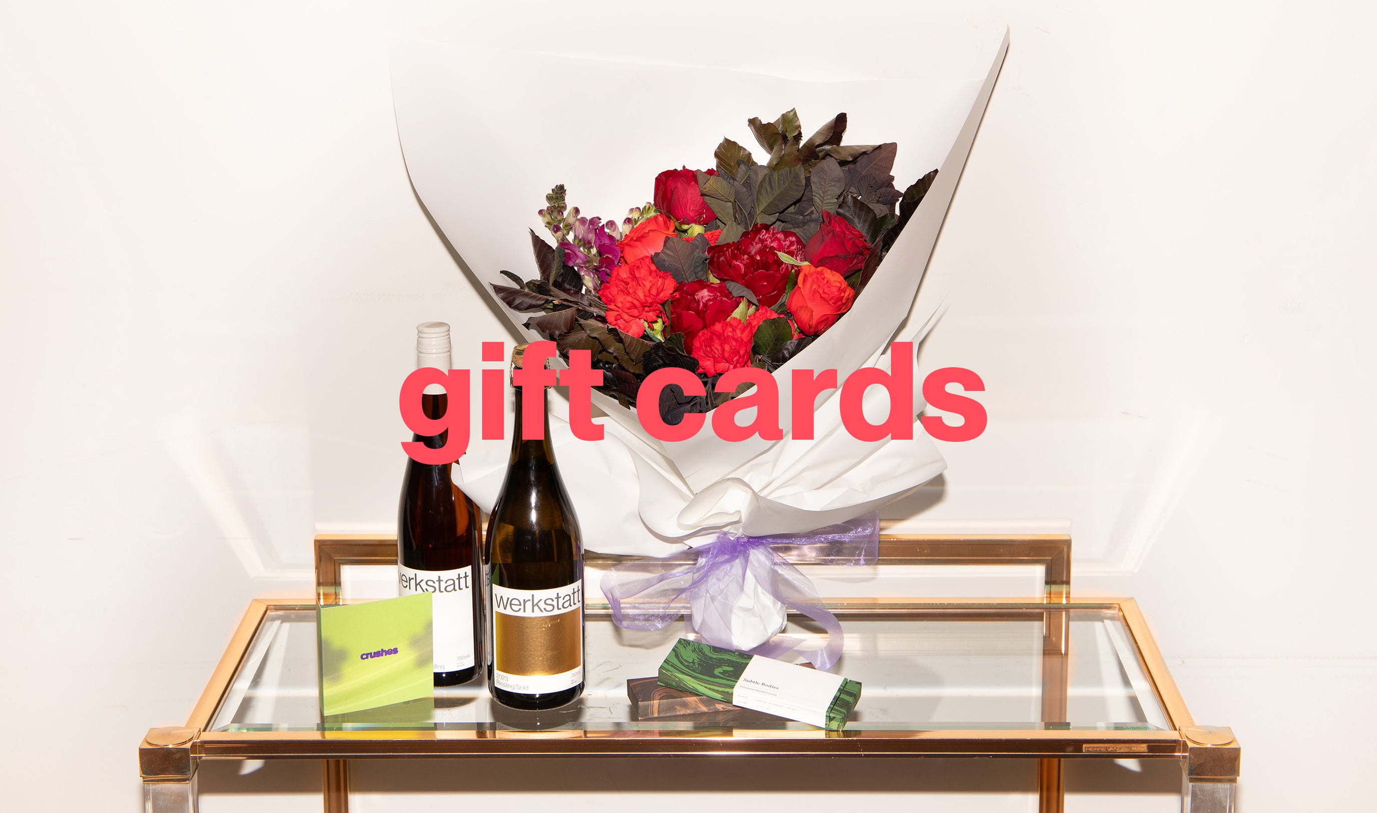 Image of various gift items on a glass table.