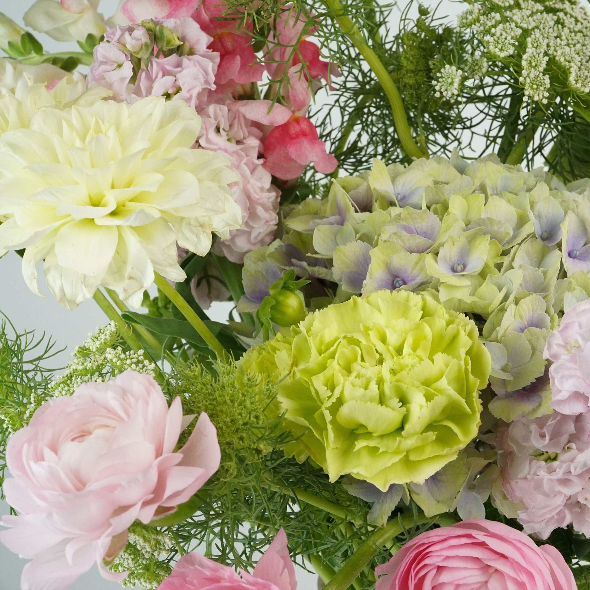 Pastel flower bouquet with hydrangea, calla lily, dahlia, ranunculus, carnations, and stock from The No.06 collection.