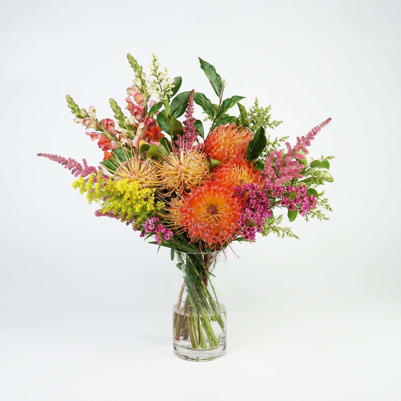 The No.03 Native Flowers floral arrangement with colorful native blooms and foliage in a clear vase.