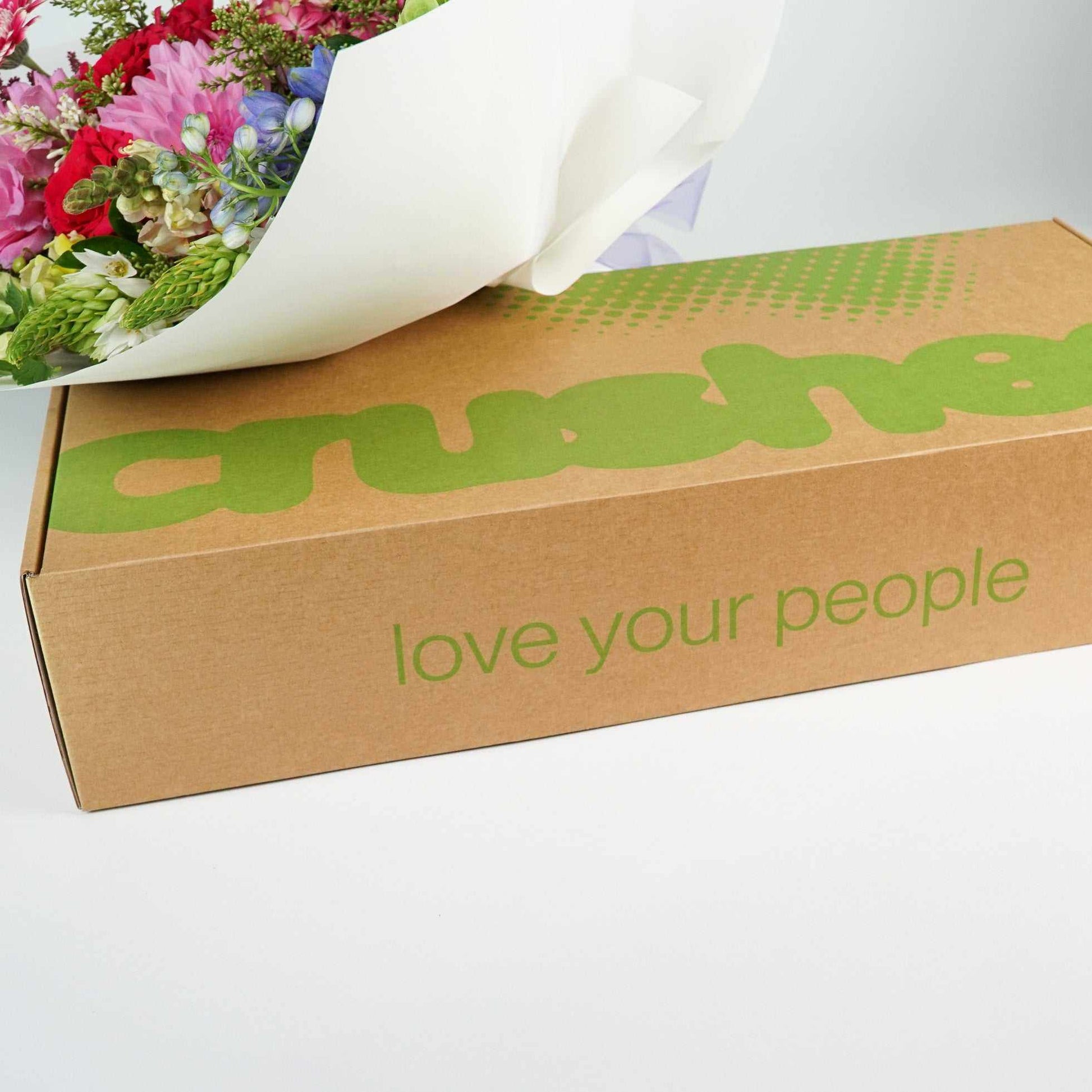 Flowers placed on a box labeled "love your people." Showing how your Crushes flowers are delivered. Colour Crush