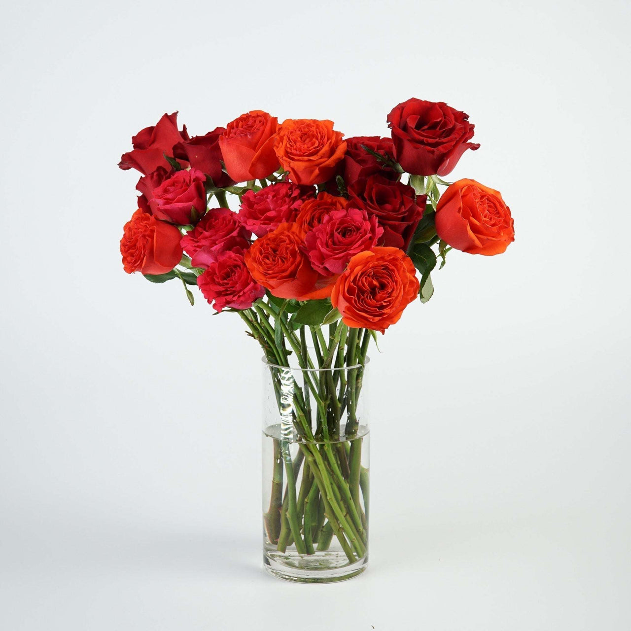 The Icons - Roses Your Way bouquet of 20 colorful roses in a glass vase.