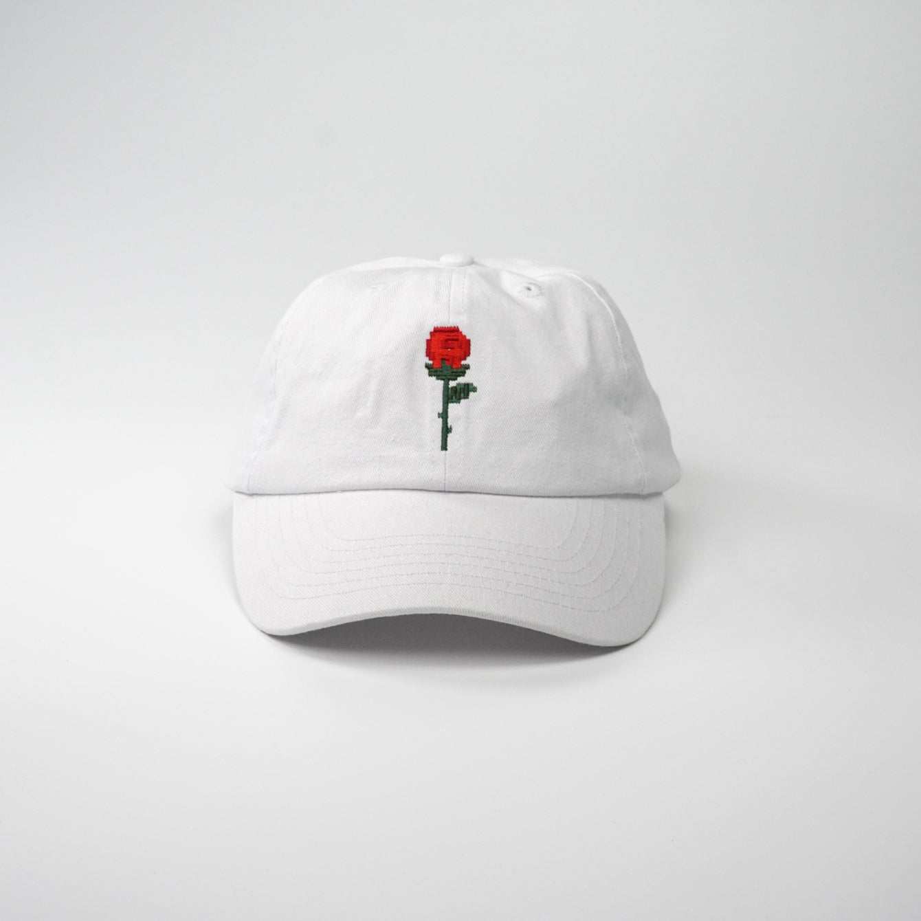 Crushes Pixel Rose White Cotton Cap with embroidered red rose design.