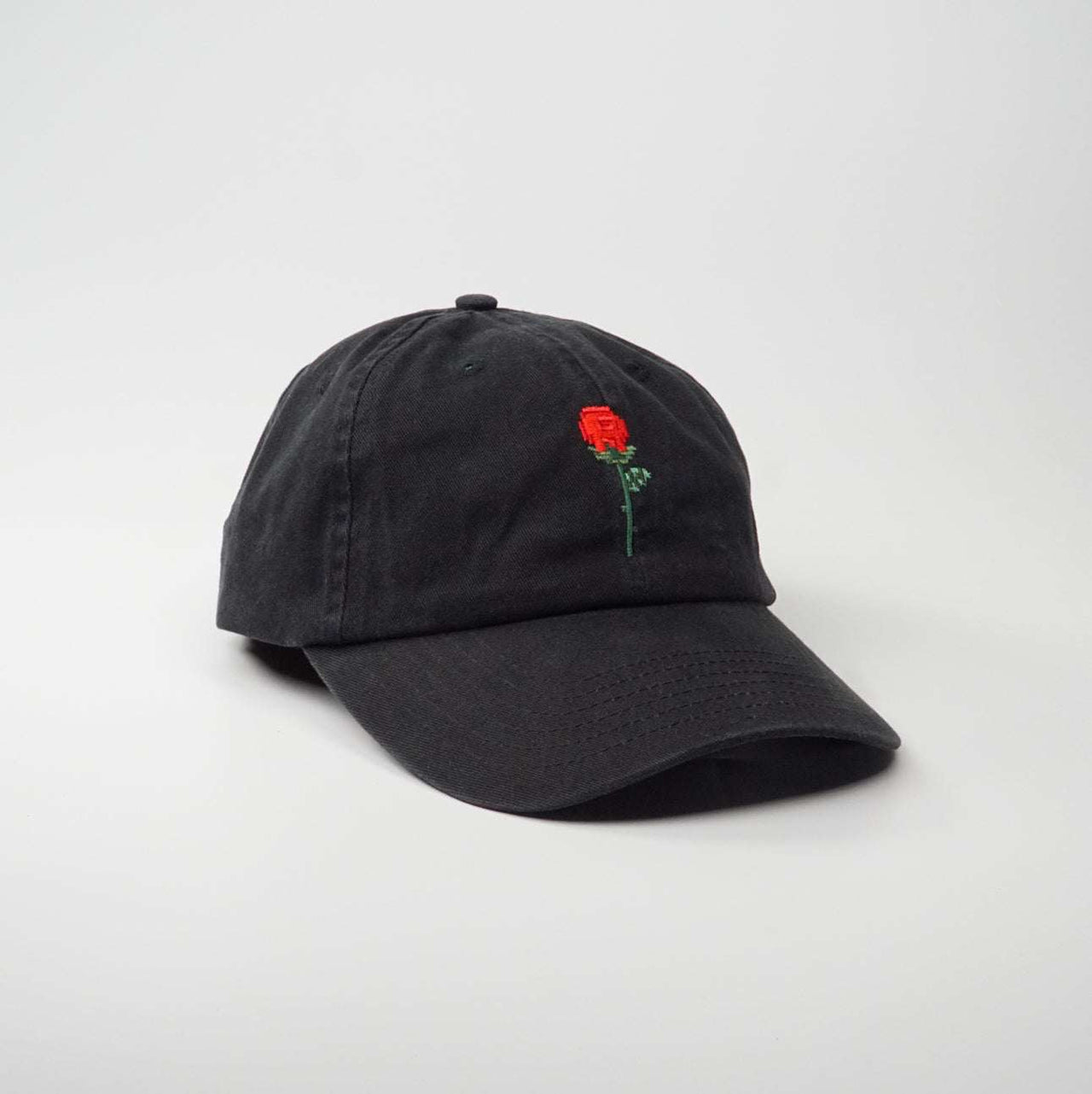 Adjustable Black Cotton Cap with an embroidered pixel rose design, made from 100% cotton.