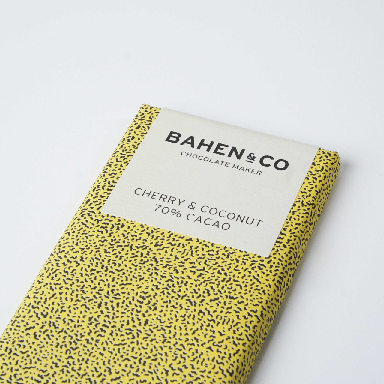 Bahen&Co Coconut & Cherry Chocolate bar with yellow packaging and speckled design.