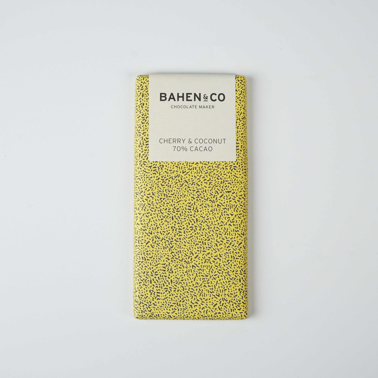 Bahen&Co Coconut & Cherry Chocolate bar with yellow packaging and speckled design.