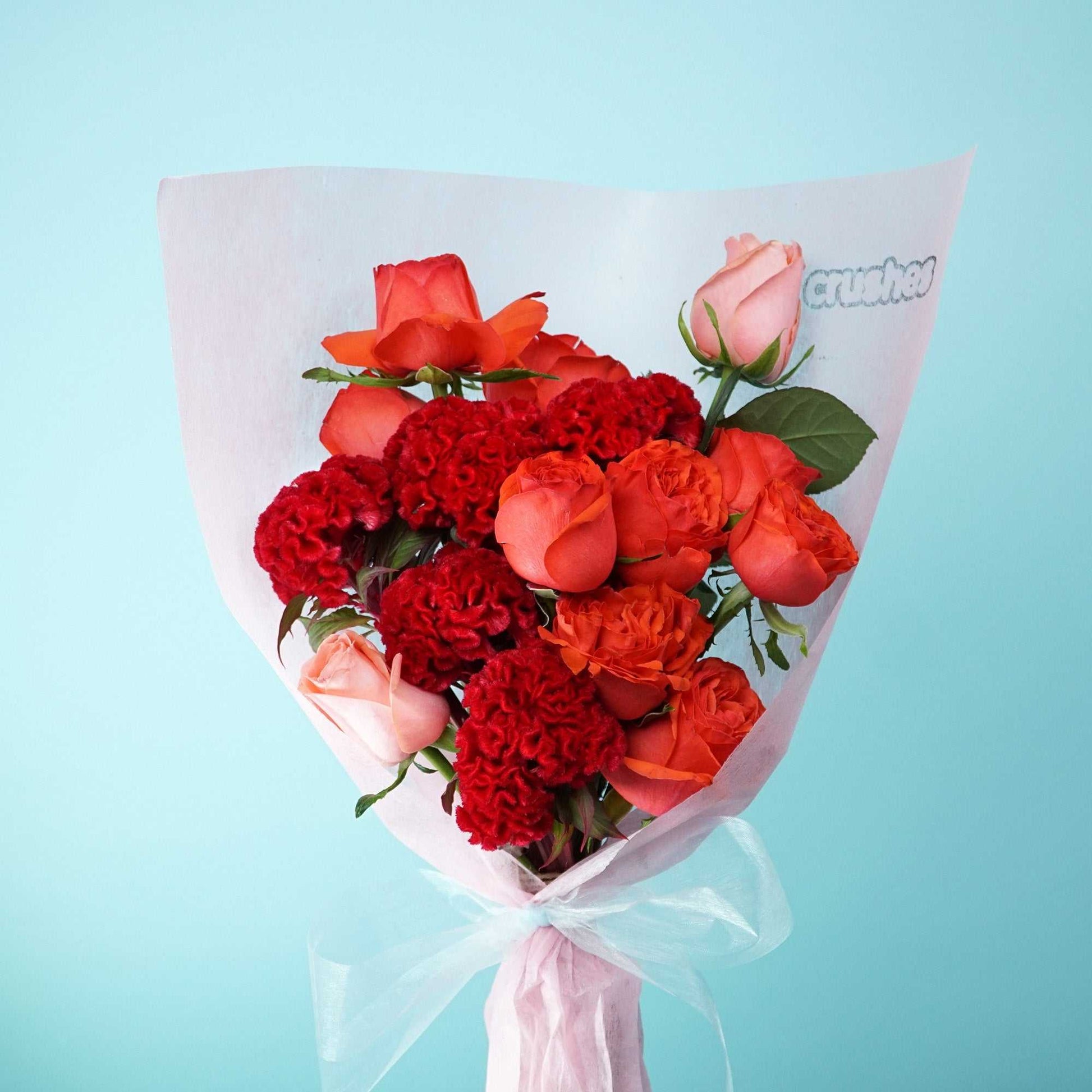 The No.10 Roses With a Twist bouquet with mixed roses and velvety celosia blooms.