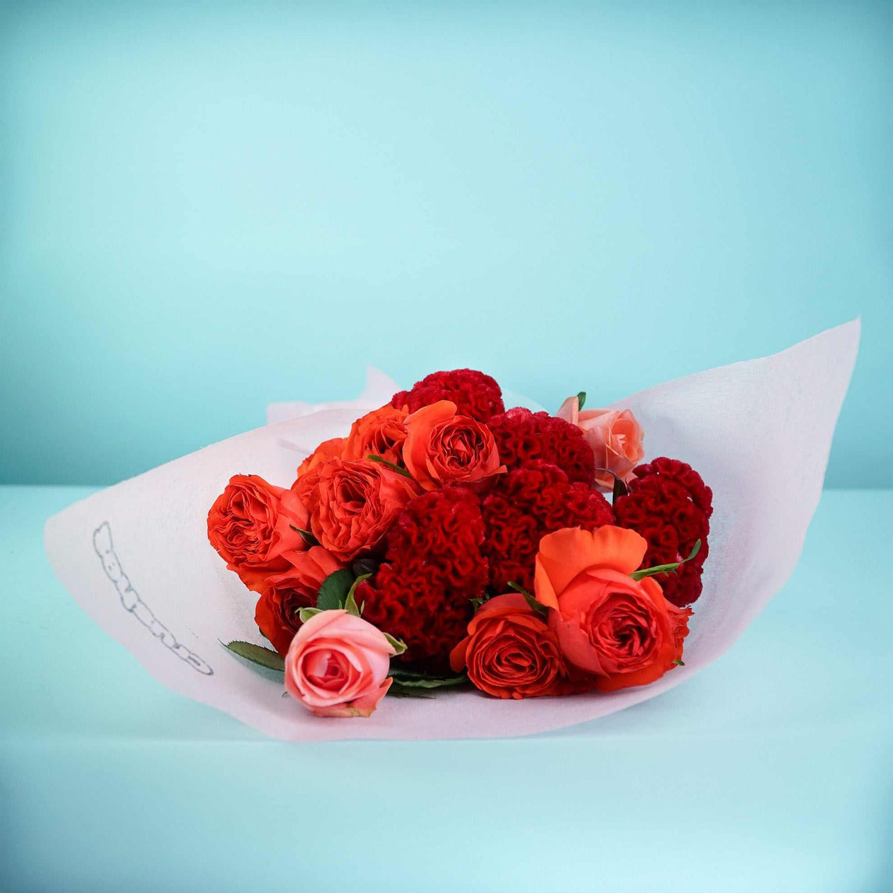 The No.10 Roses With a Twist bouquet with mixed roses and velvety celosia blooms.