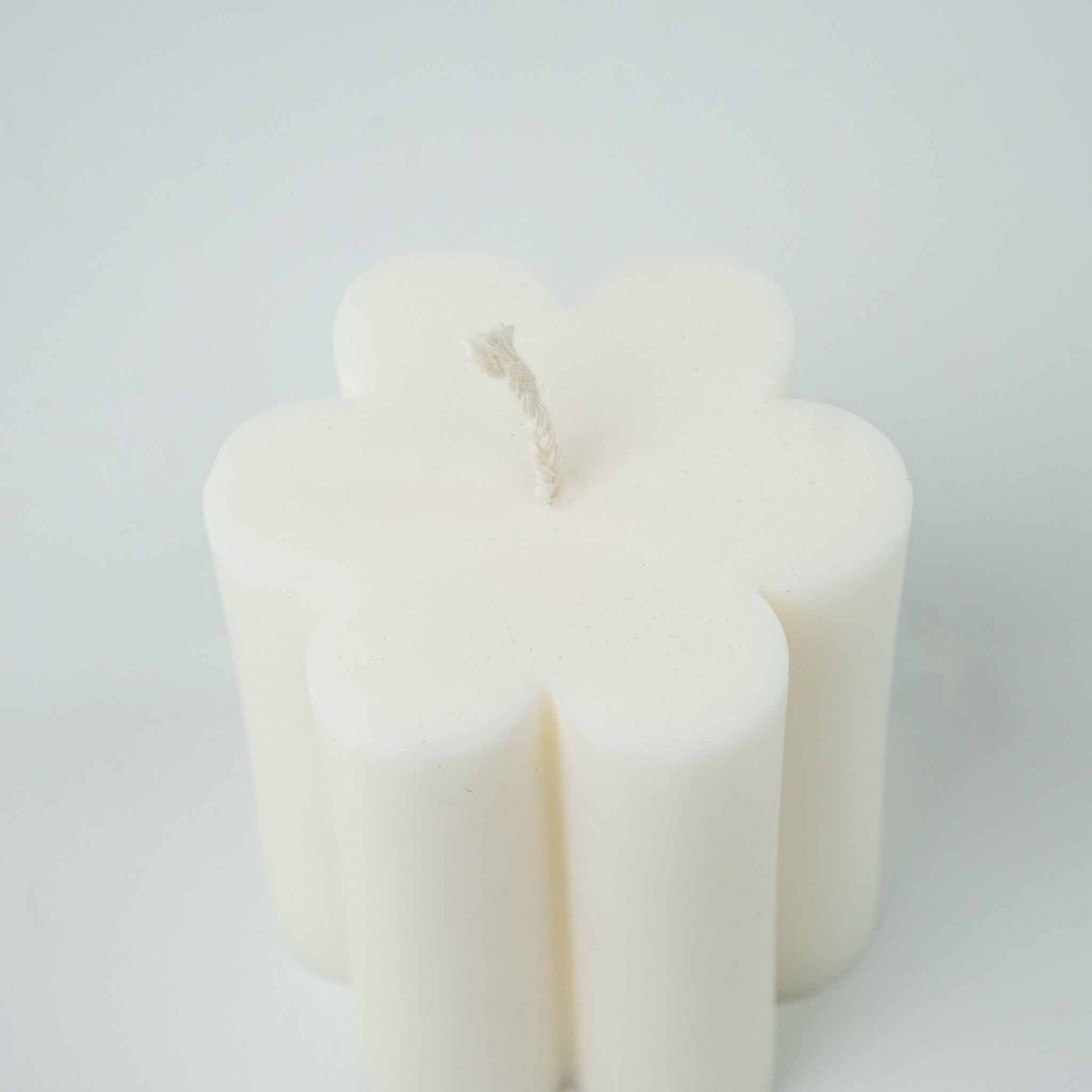 Flower candle with a central wick, perfect for decorative arrangements.