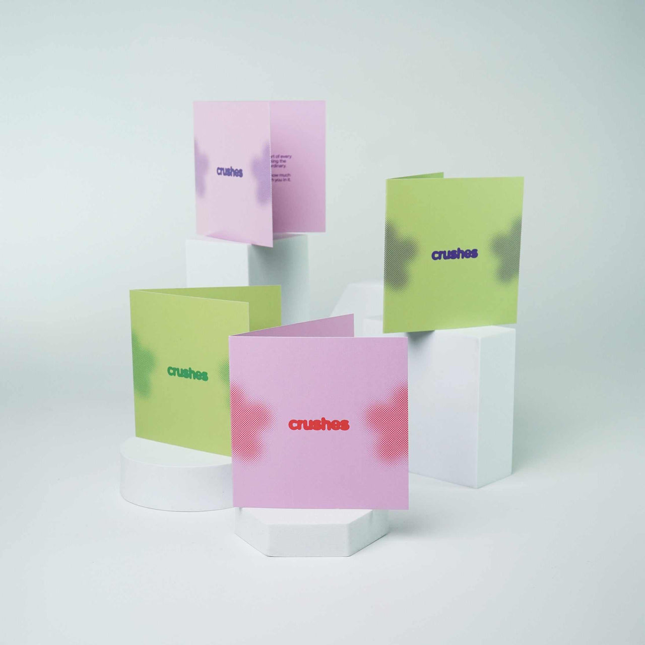 Colorful Greeting Cards displayed on white stands.