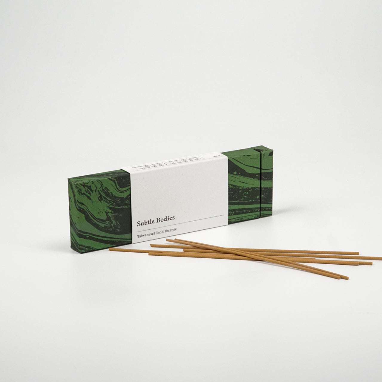 Thai Hinoki Incense sticks with packaging, sustainable plantation, woody scent, 25 sticks, 30-minute burn time.