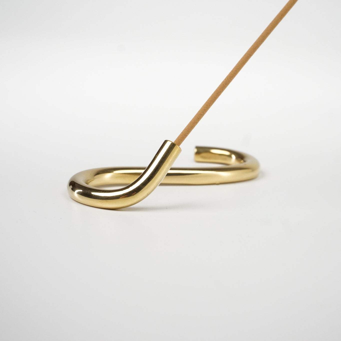 Handcrafted brass incense holder "The Snake" by Subtle Bodies, crafted in Northern India.