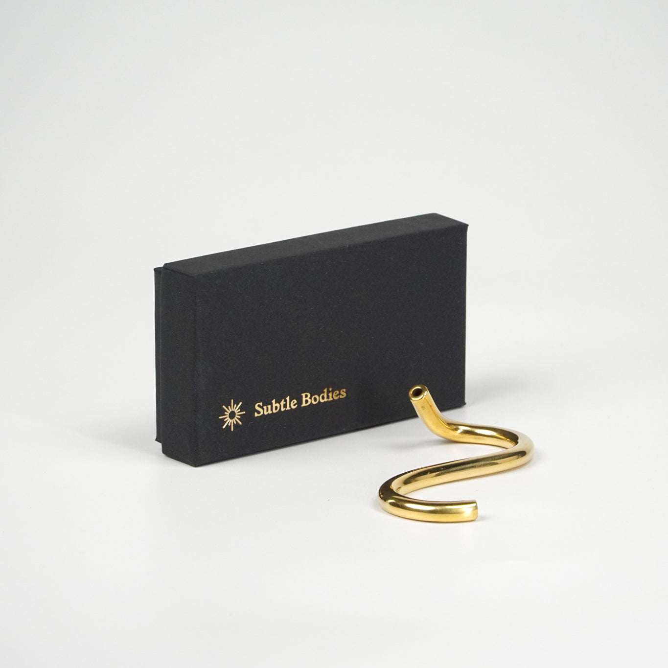 Handcrafted brass snake incense holder from Subtle Bodies with gift box.