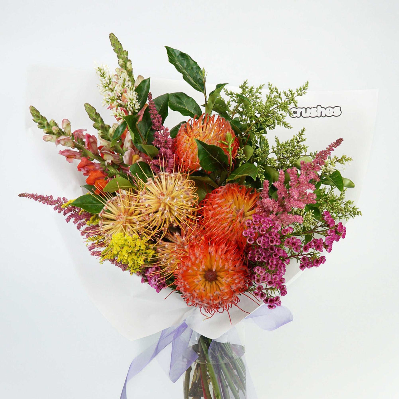 Brightly coloured native fowers arranged with folliage delivered in Melbourne from crushes flowers