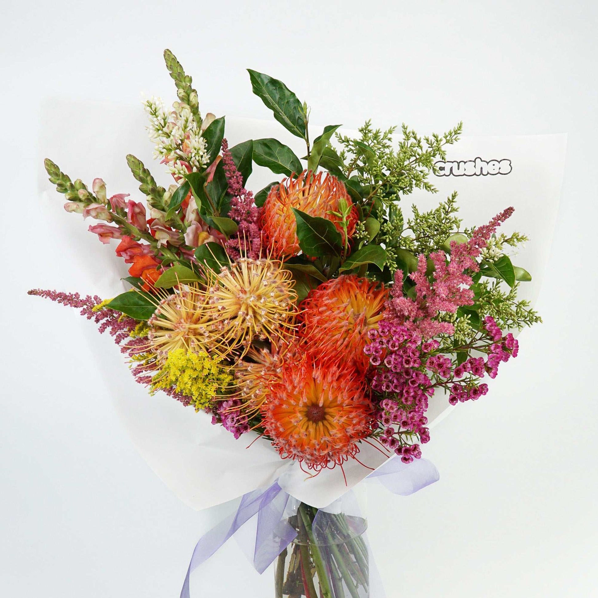 Brightly coloured native fowers arranged with folliage delivered in Melbourne from crushes flowers