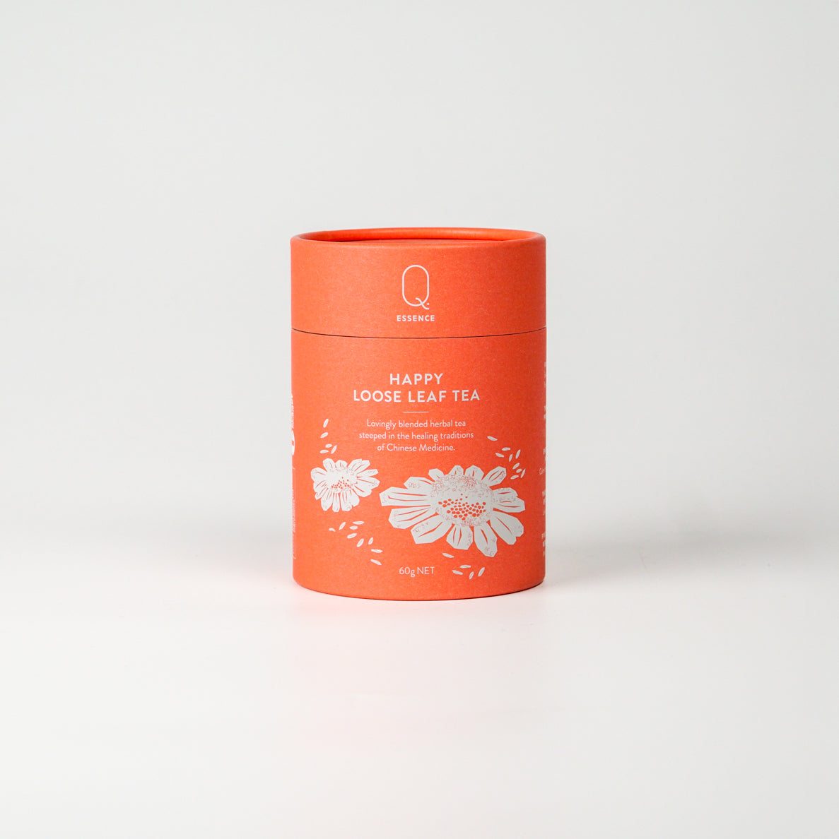 Orange cylindrical packaging of "Happy Tea" loose leaf blend with floral design.