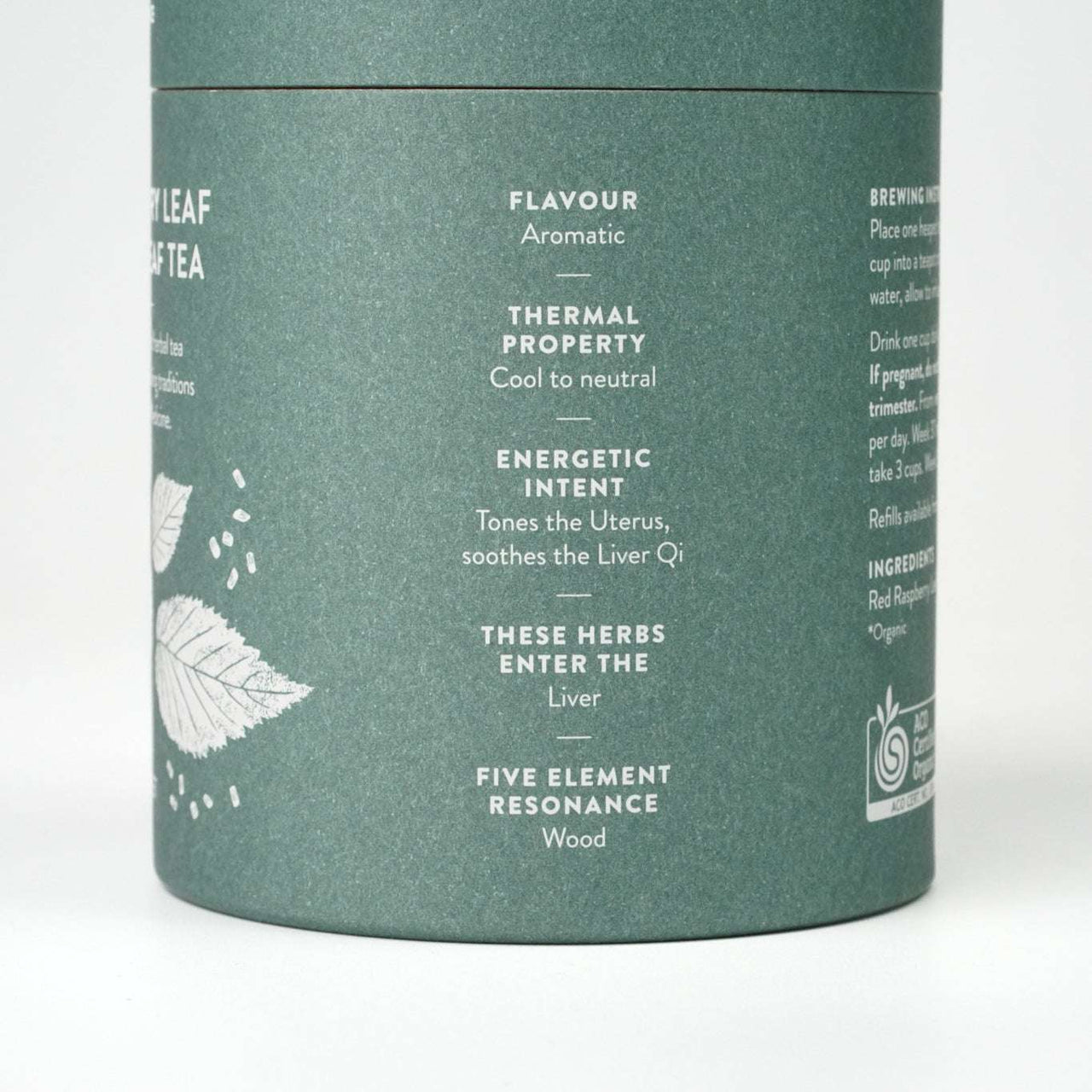 Organic raspberry tea in a green cylindrical container.