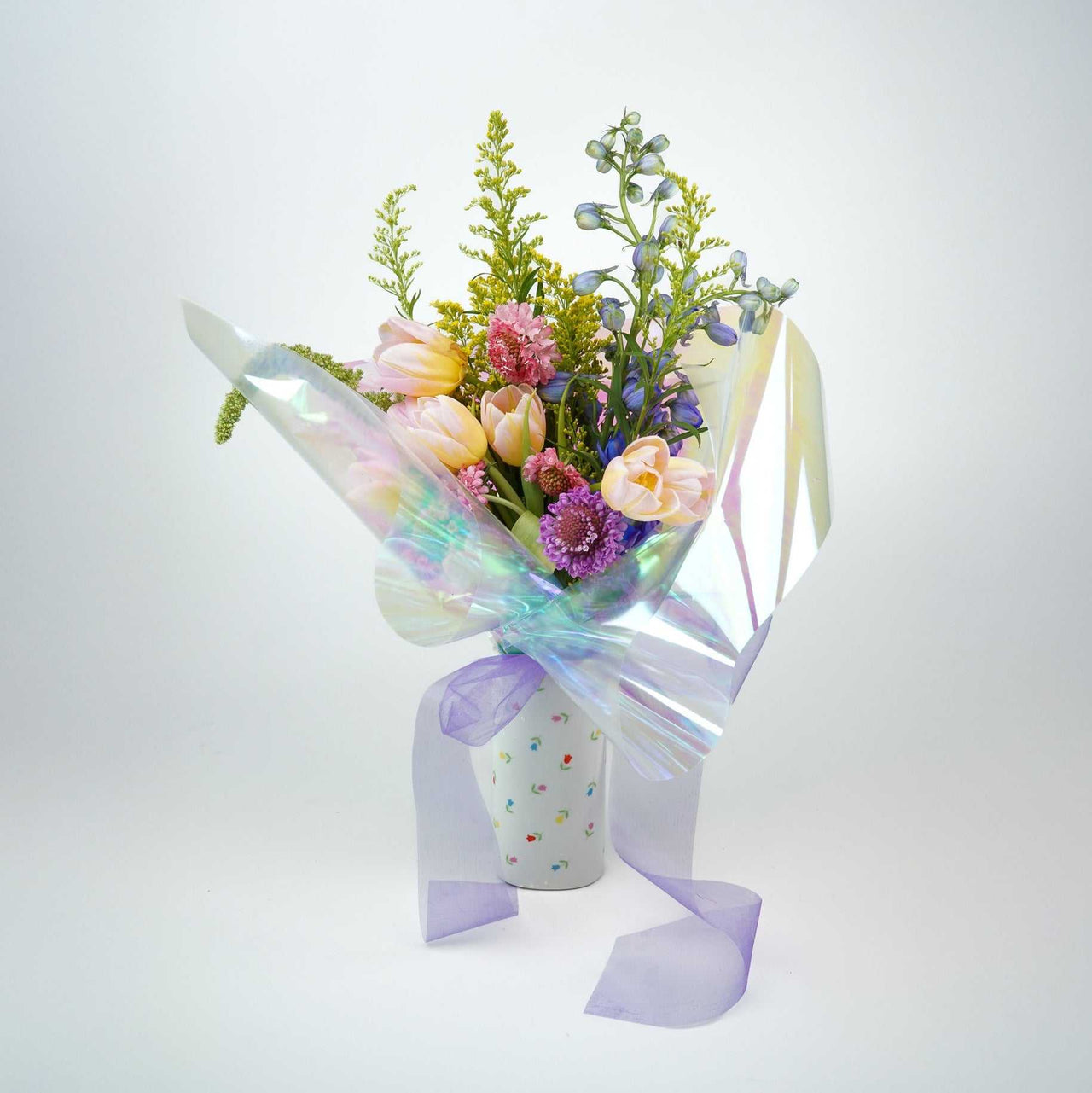 The No.01 Florist choice bouquet with tulips, delphinium, pincushions, and assorted field flowers in a decorative vase.