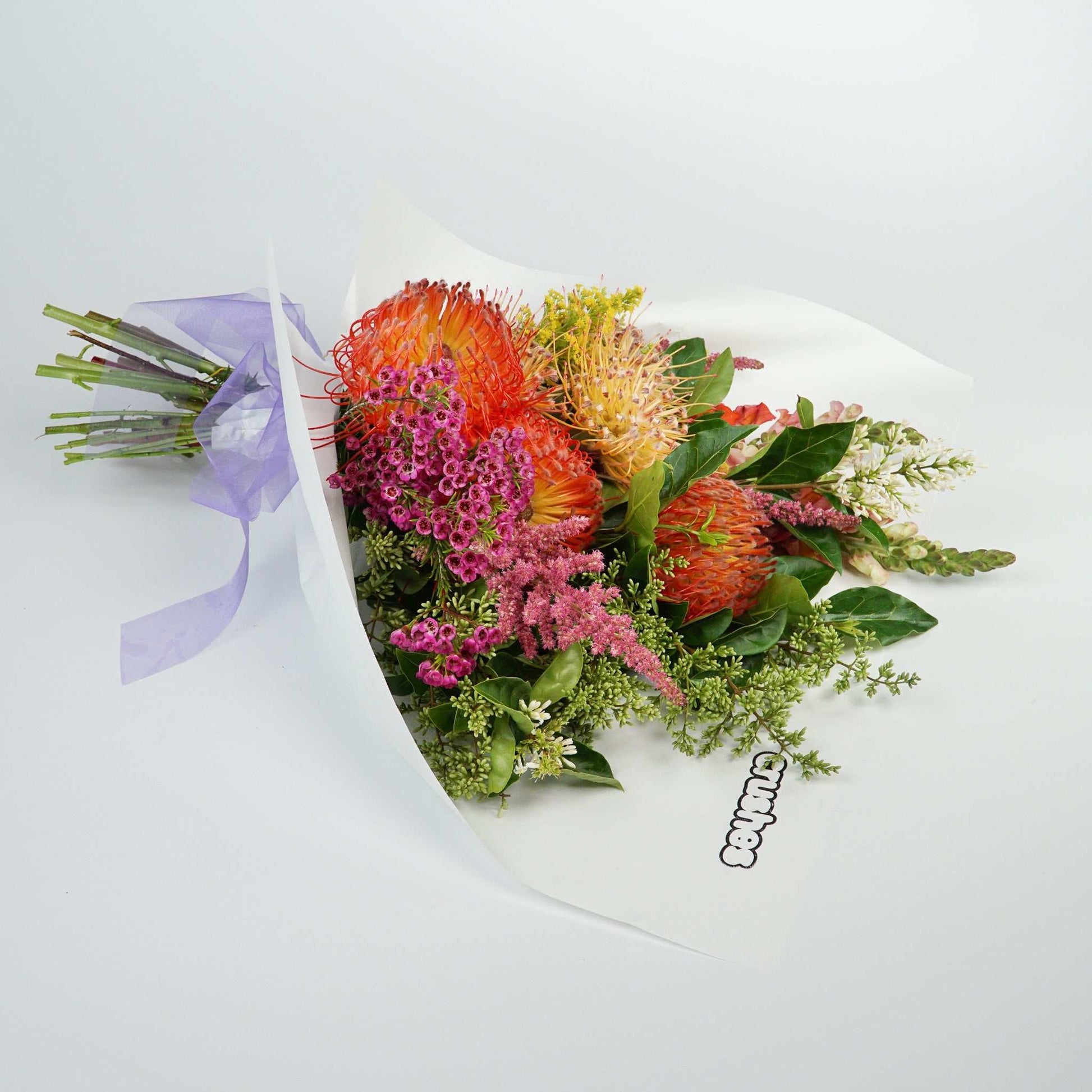 Native Flowers arrangement with vibrant blooms, including multi-colored pin cushions and bright pink wax flowers, titled 'The No.03 - Native Crush'.