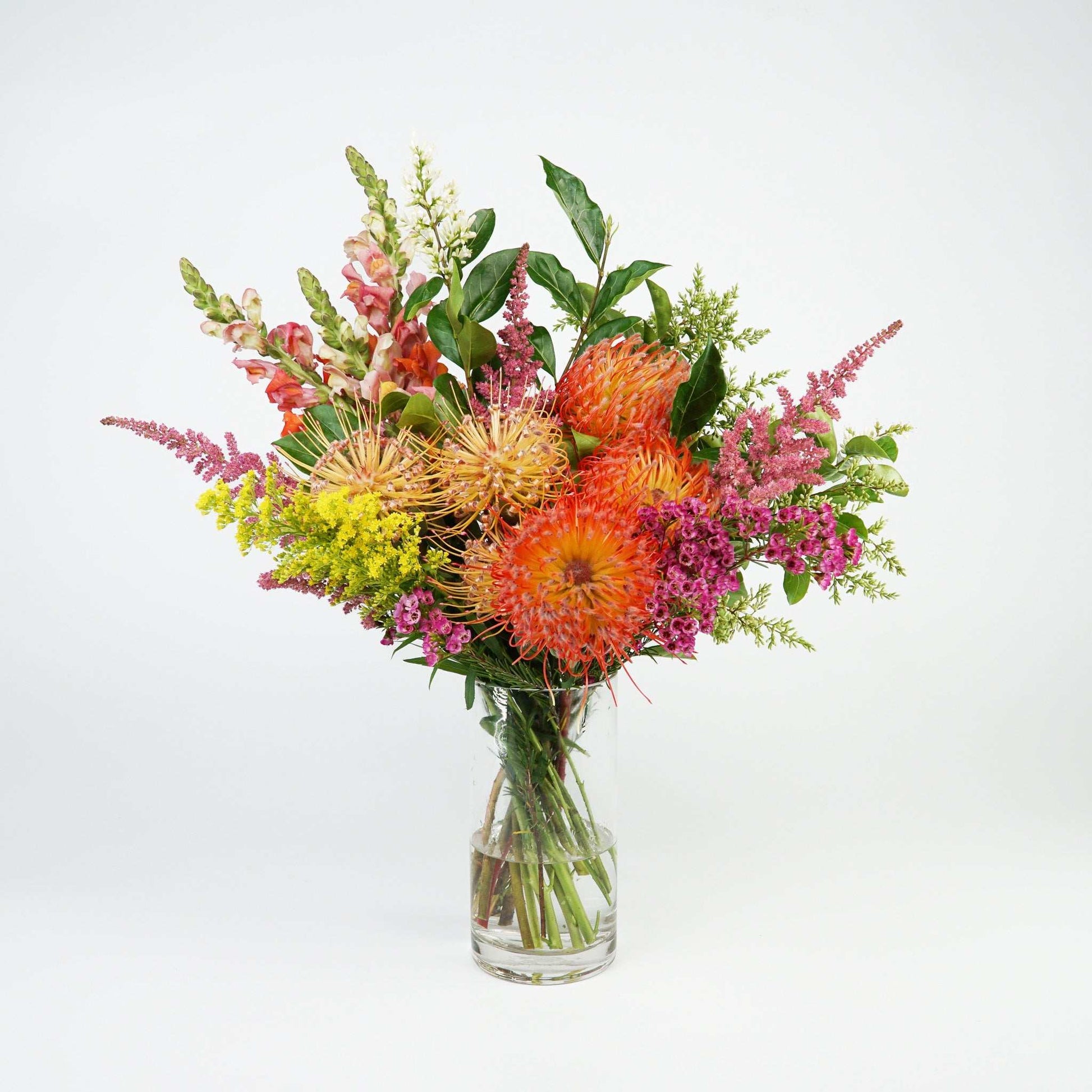 The No.03 Native Flowers floral arrangement with colorful native blooms and foliage in a clear vase.
