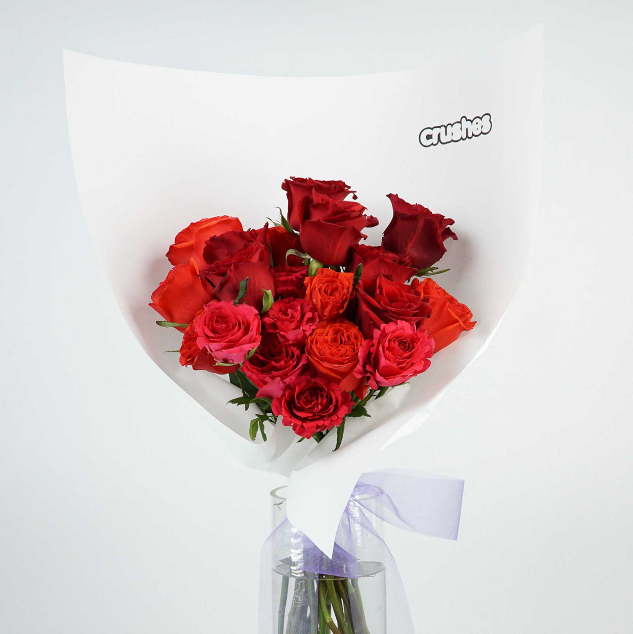 A bouquet of 20 classic roses wrapped in white paper, showcasing their rich colors and fresh petals.