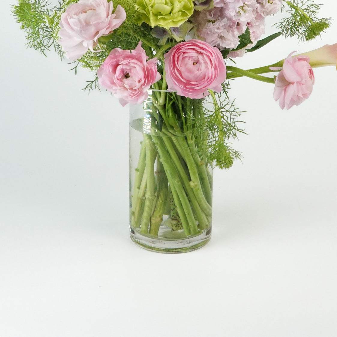 Elegant Fine Glass Vase displaying a lush floral arrangement.